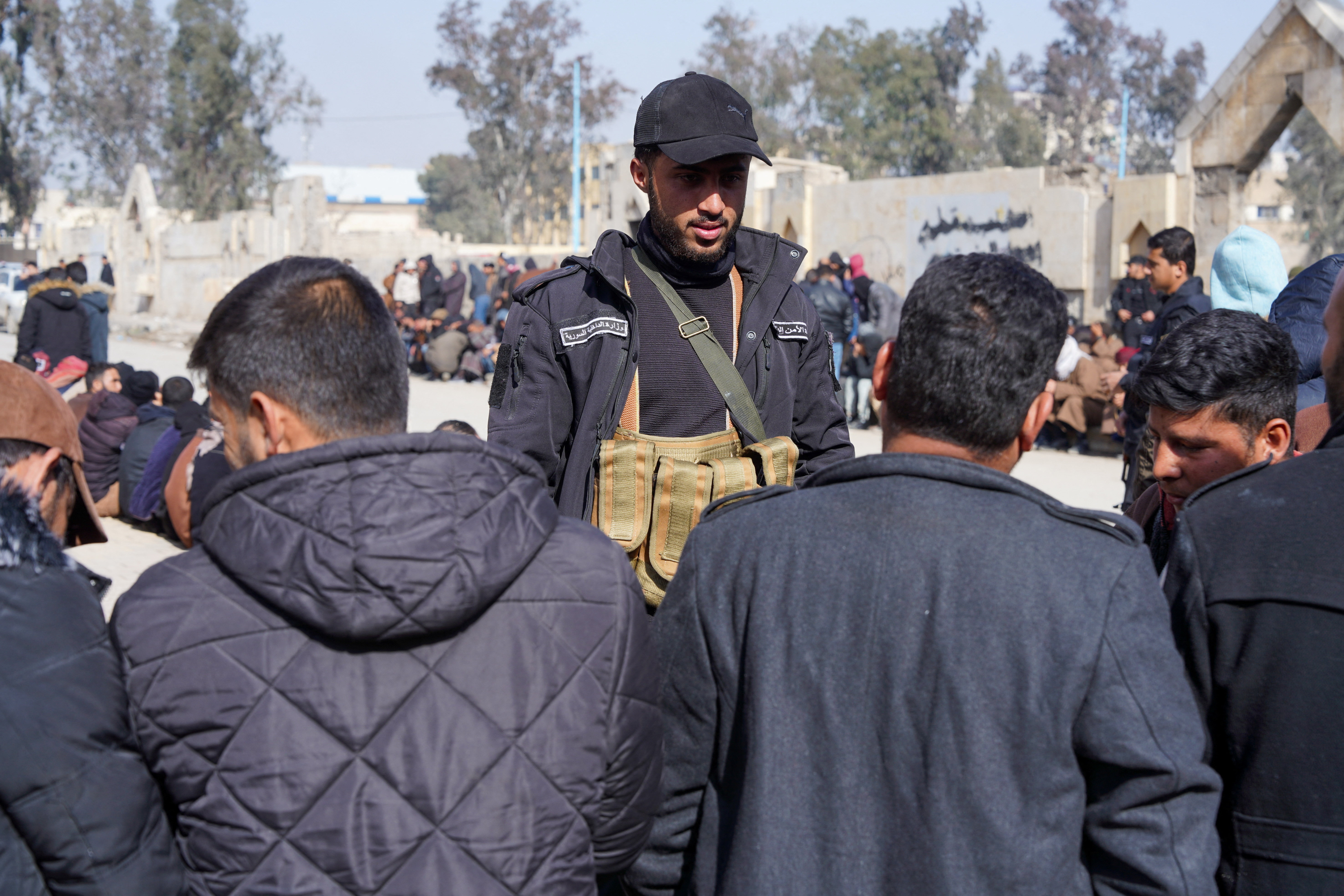 Members of the Kurdish-led Syrian Democratic Forces (SDF) queue to settle their status with Syrian government in Raqqa