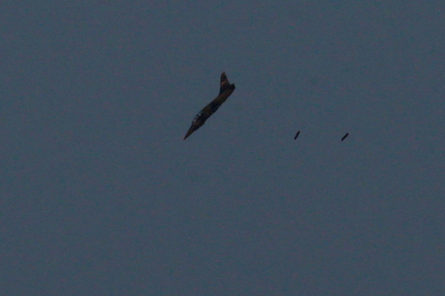 FILE PHOTO: A warplane carries out a bombing run above Syria near the Israeli-Syrian border as it is seen from the Israeli-occupied Golan Heights