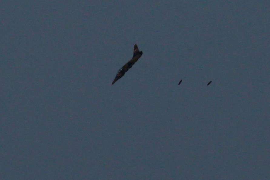FILE PHOTO: A warplane carries out a bombing run above Syria near the Israeli-Syrian border as it is seen from the Israeli-occupied Golan Heights
