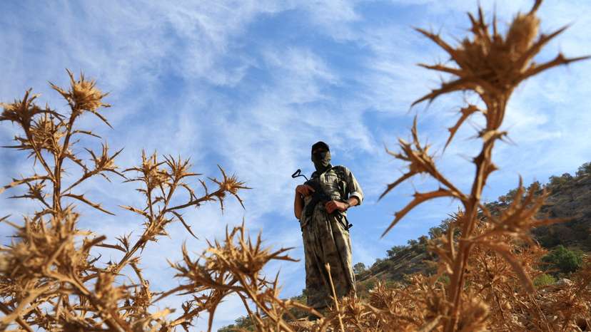 A fighter with the Kurdistan Workers' Party (PKK) stands guard in the Qandil mountains
