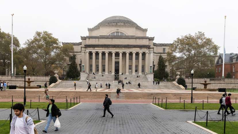 People walk past Columbia University in New York