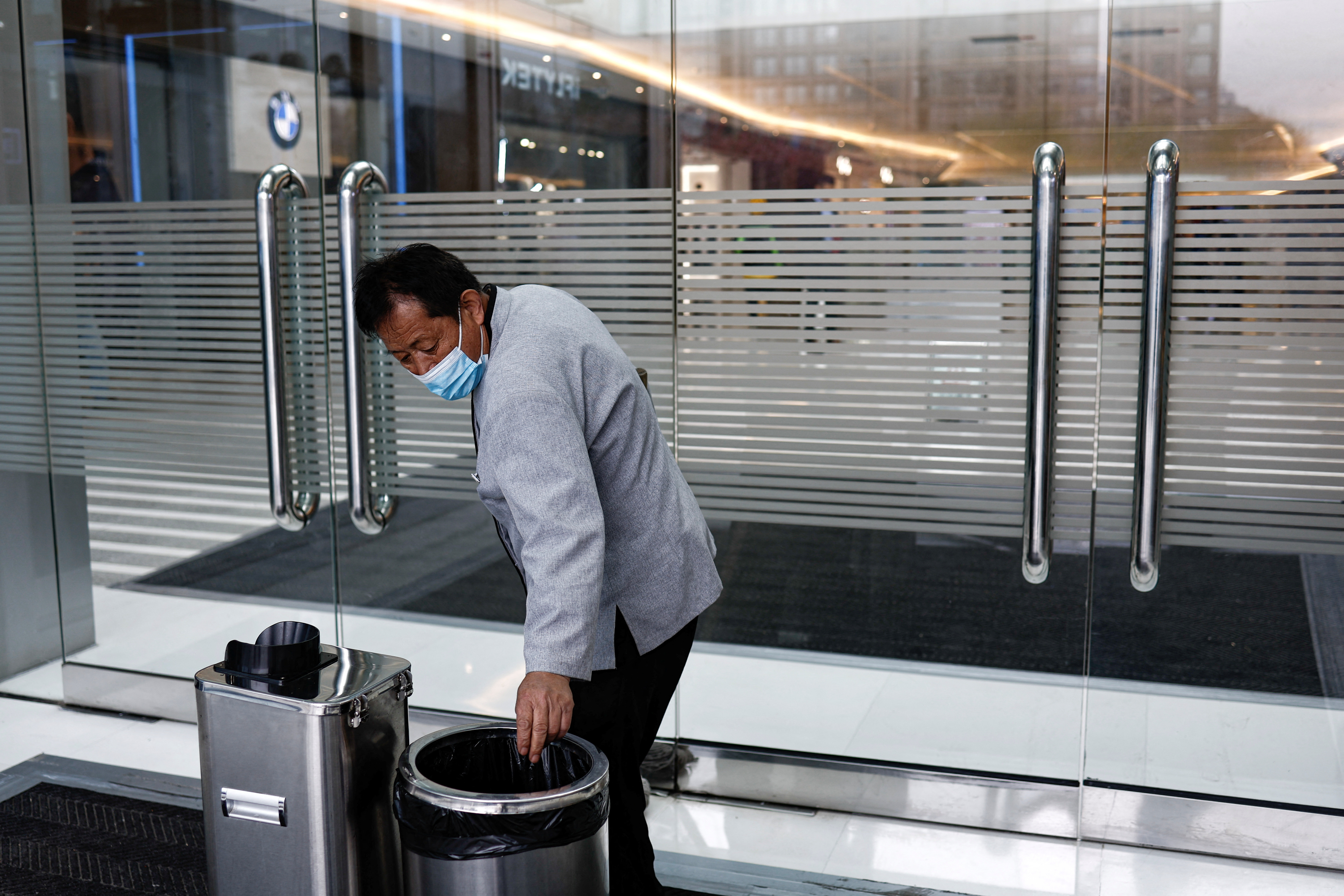 Cleaning worker Hu works at a shopping mall in Beijing