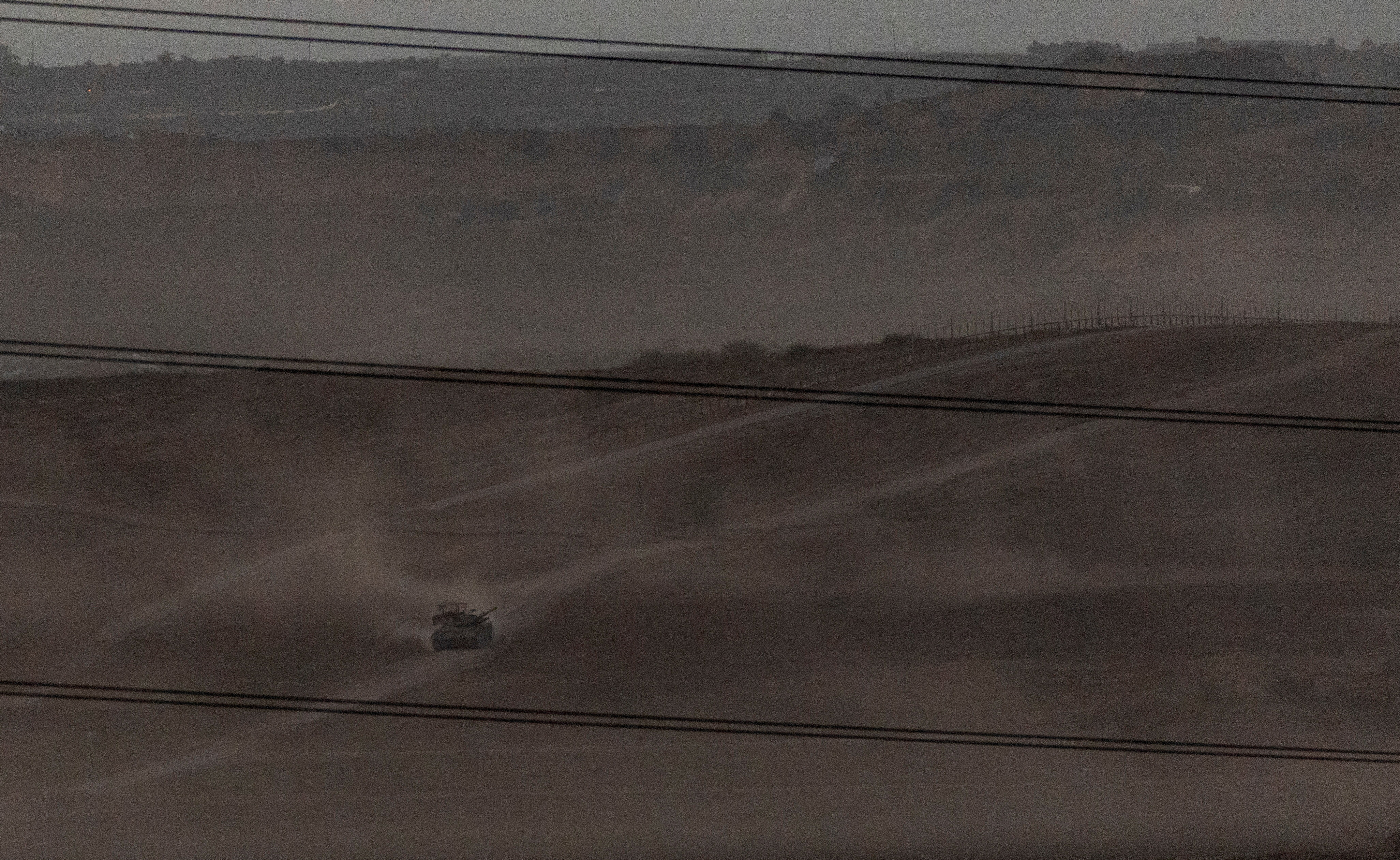 FILE PHOTO: Israeli troops manoeuvre near the Israel-Gaza border, as seen from the southern Israel
