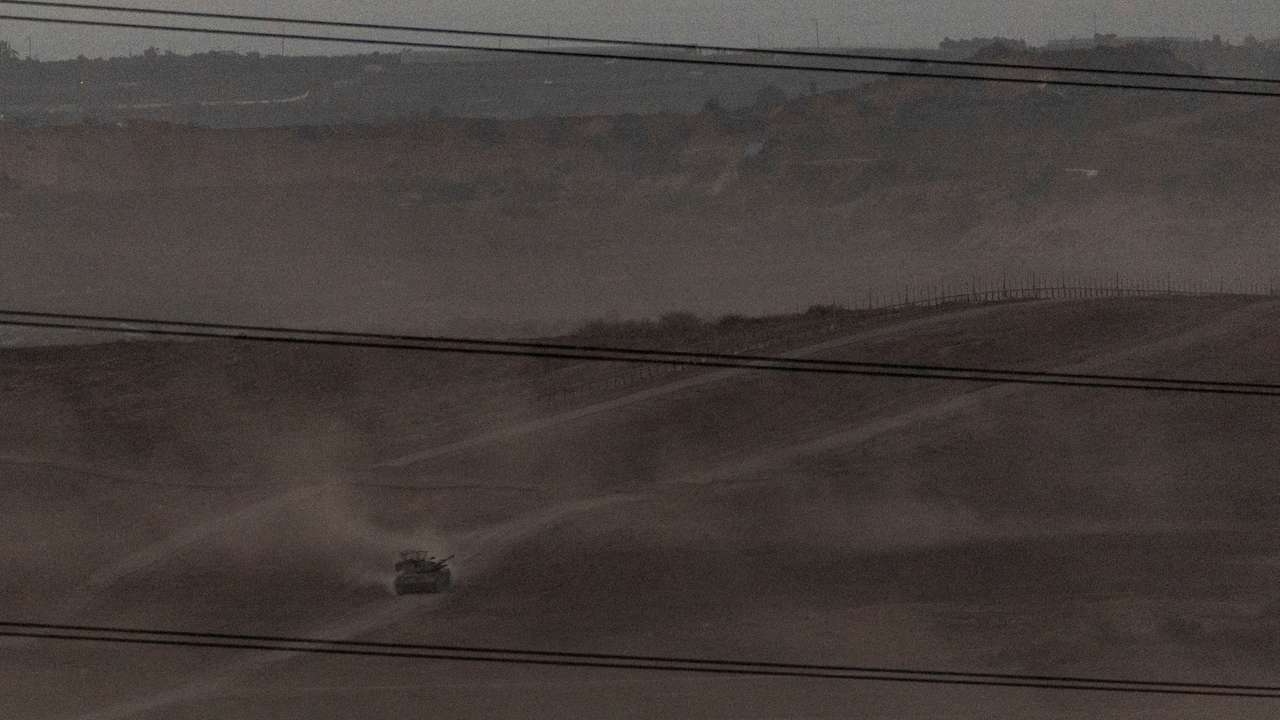 FILE PHOTO: Israeli troops manoeuvre near the Israel-Gaza border, as seen from the southern Israel