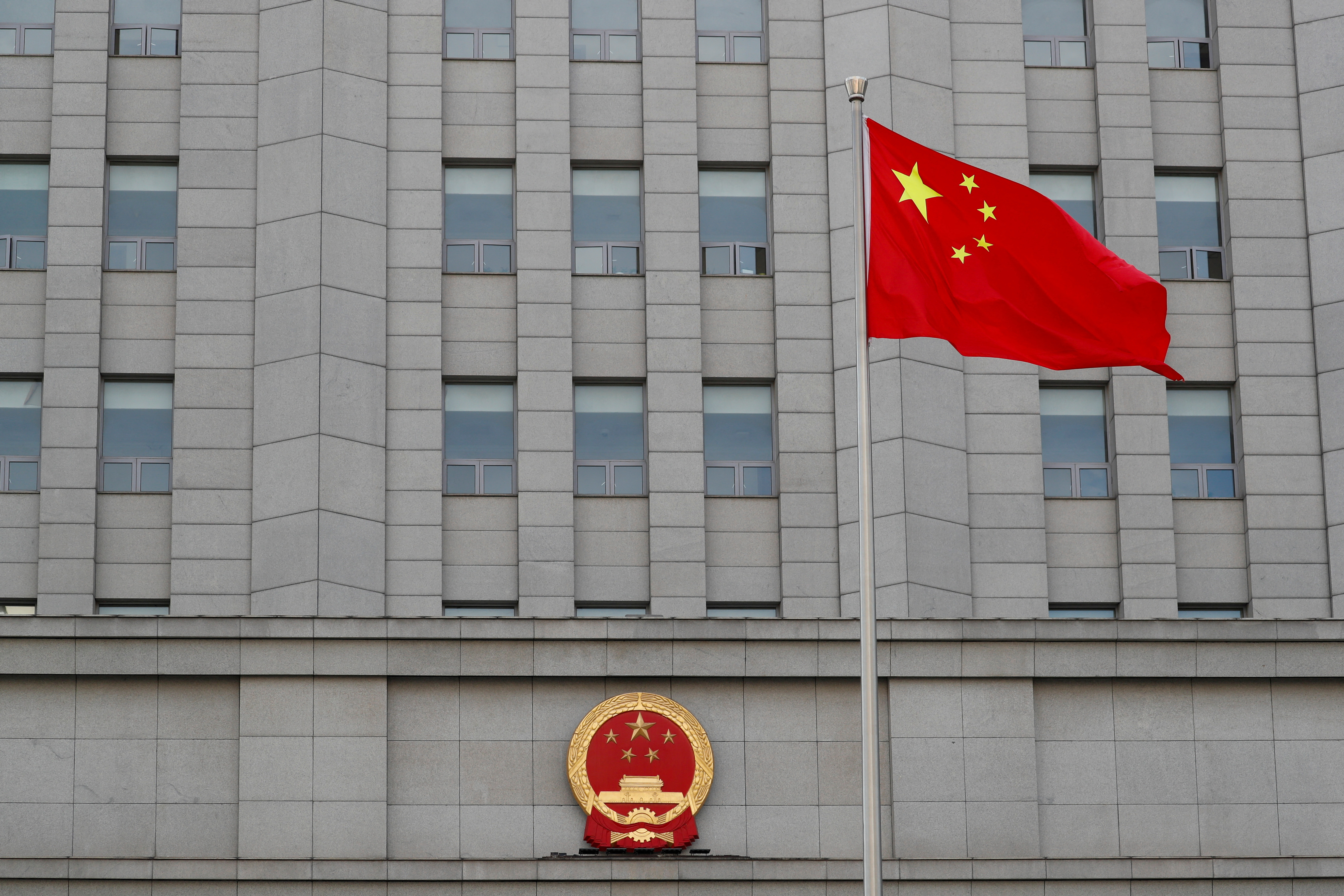 FILE PHOTO: FILE PHOTO: A Chinese national flag waves outside Beijing No. 2 Intermediate People's Court where Australian writer Yang Hengjun is expected to face trial on espionage charges, in Beijing