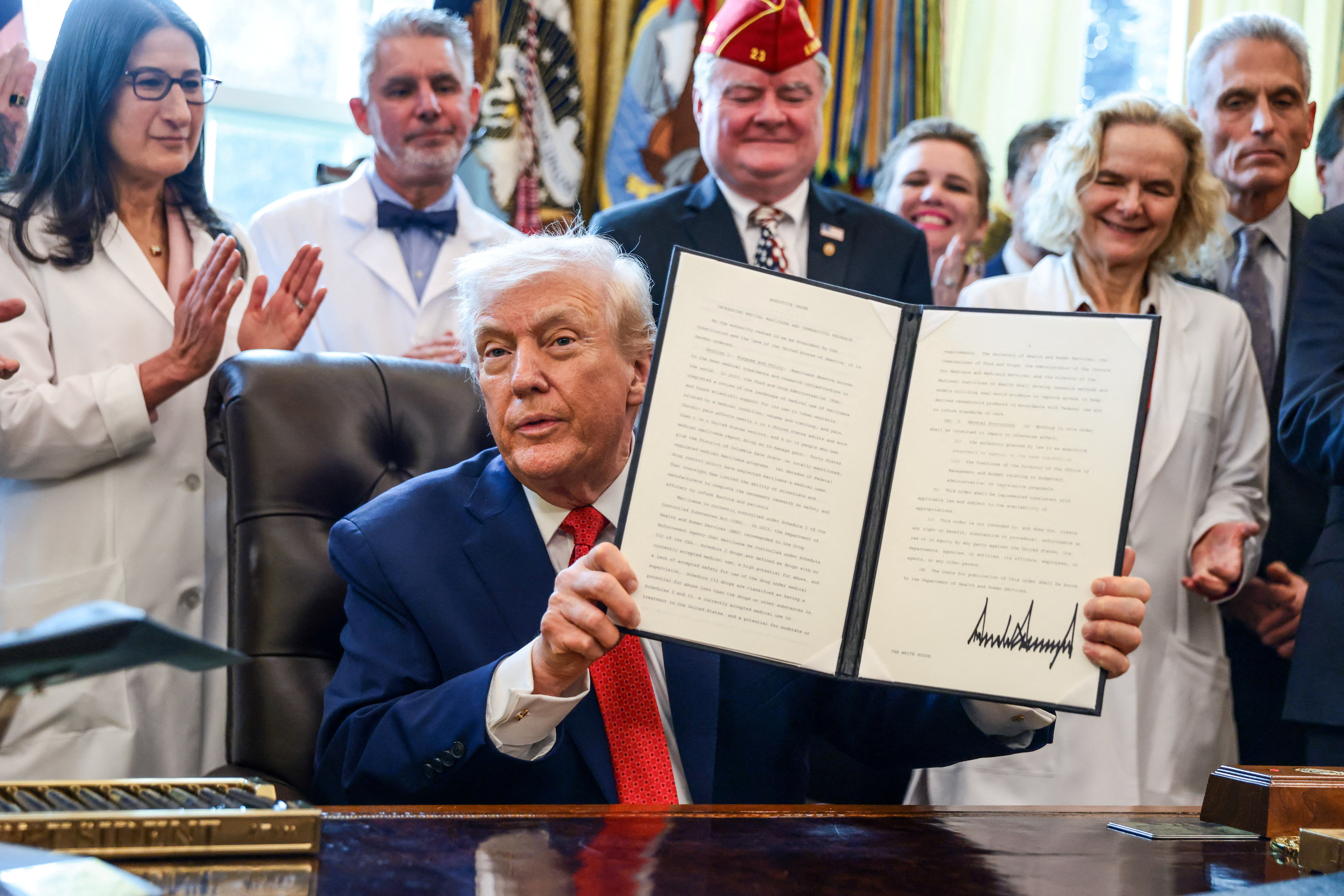 U.S. President Trump signs executive orders at the Oval Office, in Washington