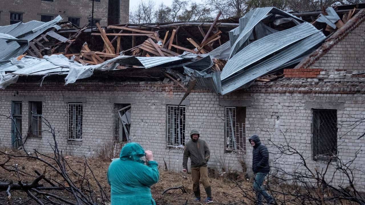 FILE PHOTO: Residents walk at a site of a Russian missile strike in Dnipro