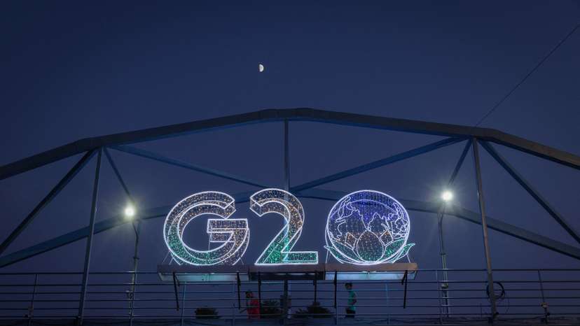 Moon is pictured above a G20 logo installed on a pedestrian bridge in front of the main venue of the summit in New Delhi