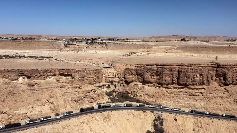 A drone view shows a trail of trucks lining up on a road near Mitzpe Ramon following a protest aiming to prevent humanitarian aid from arriving to Gaza, near Mitzpe Ramon, southern Israel