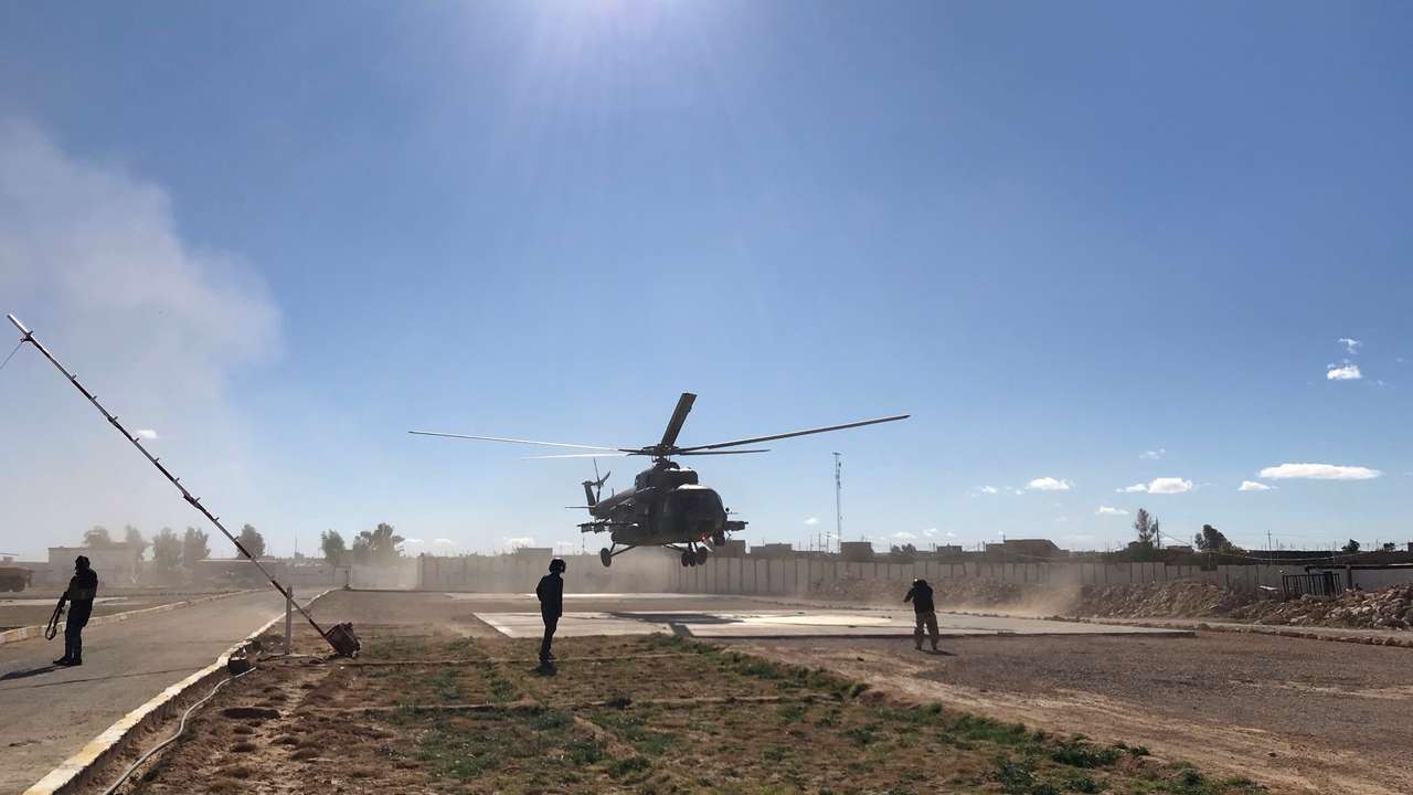 Iraqi army commanders visit by helicopter a military base near a border crossing with Syria at Al-Qaim