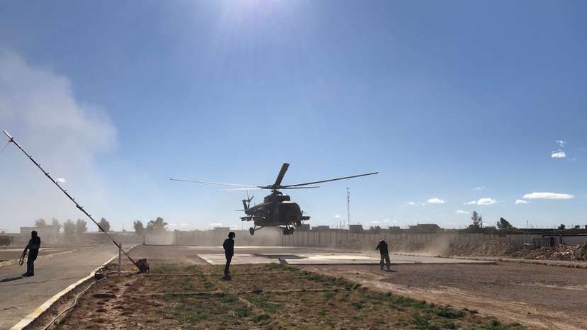 Iraqi army commanders visit by helicopter a military base near a border crossing with Syria at Al-Qaim