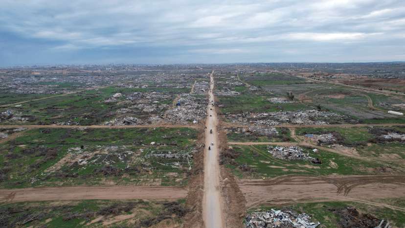 A drone view shows Palestinians making their way past the rubble after Israeli forces withdrew from the Netzarim Corridor, amid a ceasefire between Israel and Hamas, near Gaza City