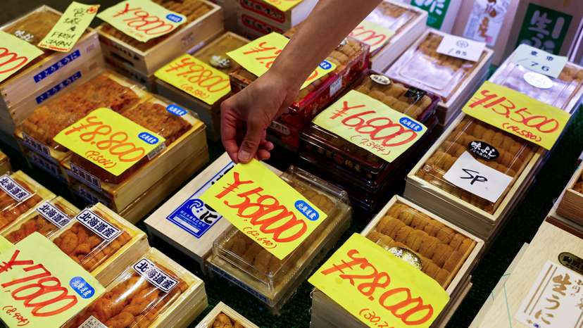 Employee at a wholesaler puts a price tag on a package of sea urchins from Hokkaido at Tsukiji Outer Market in Tokyo