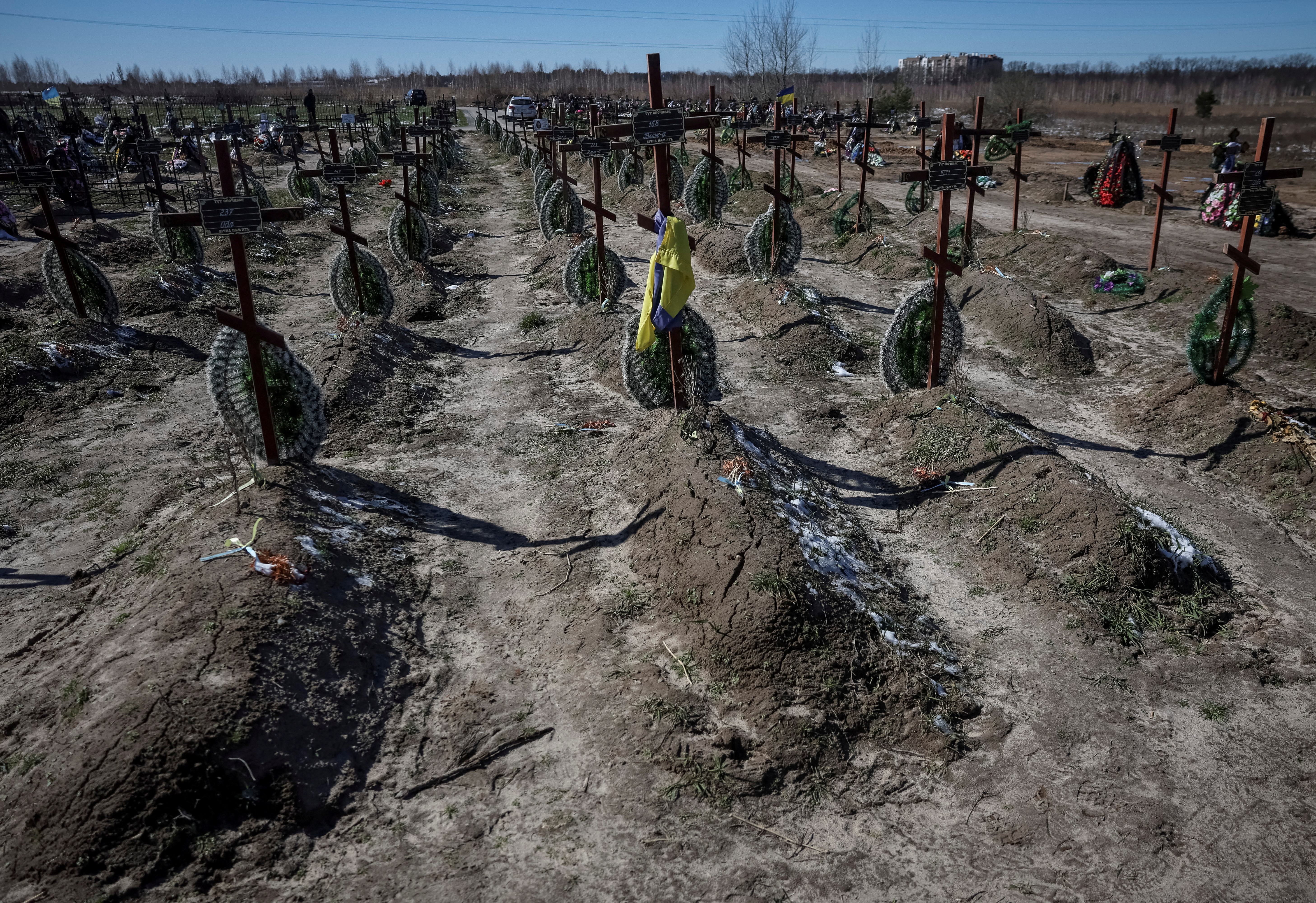 FILE PHOTO: Graves of unidentified people killed by Russian soldiers during occupation of the Bucha town, are seen at the town's cemetery outside Kyiv