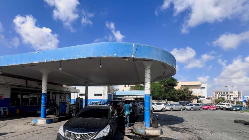FILE PHOTO: A car stands while others line up to get fuel at a gas station in Misrata
