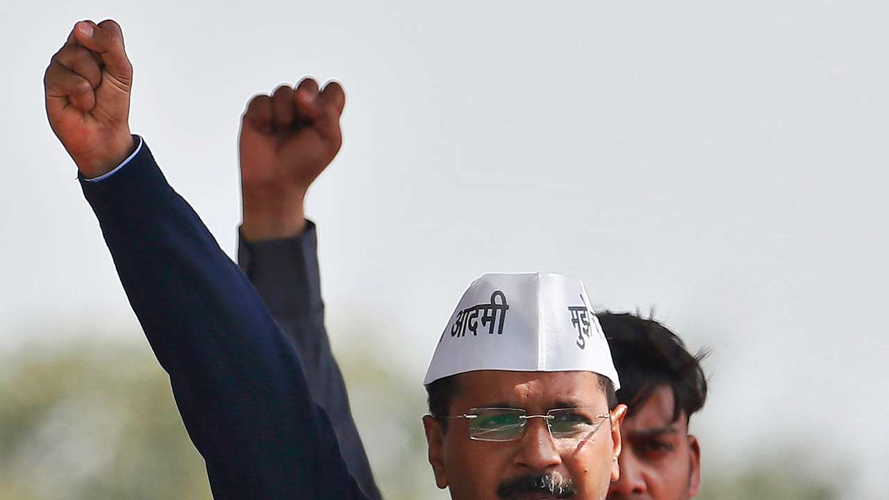 Kejriwal, chief of AAP shouts slogans after taking the oath as the new chief minister of Delhi during a swearing-in ceremony at Ramlila ground in New Delhi