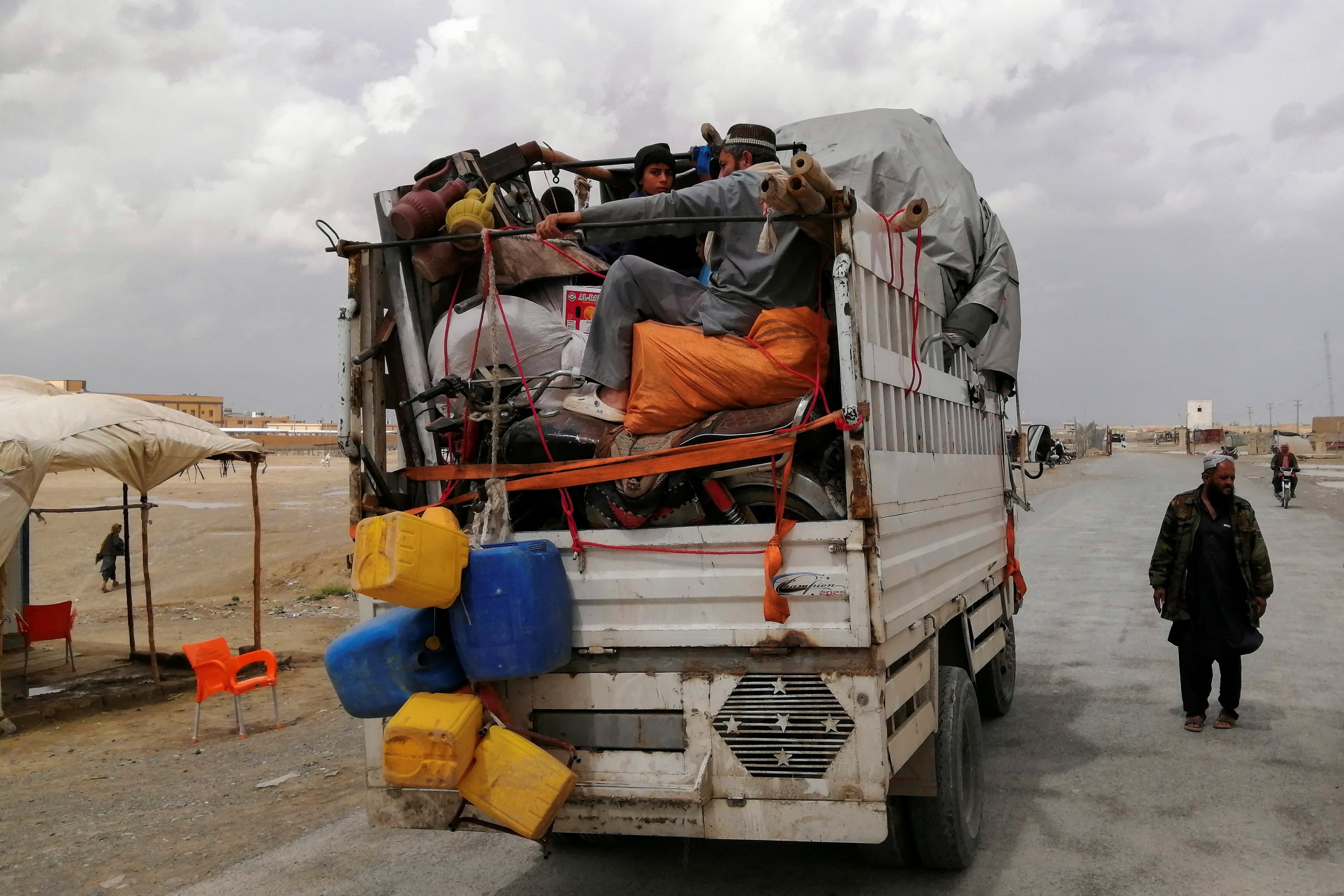 An Afghan family travels with their belongings in a vehicle as they leave for their country at the Chaman border crossing