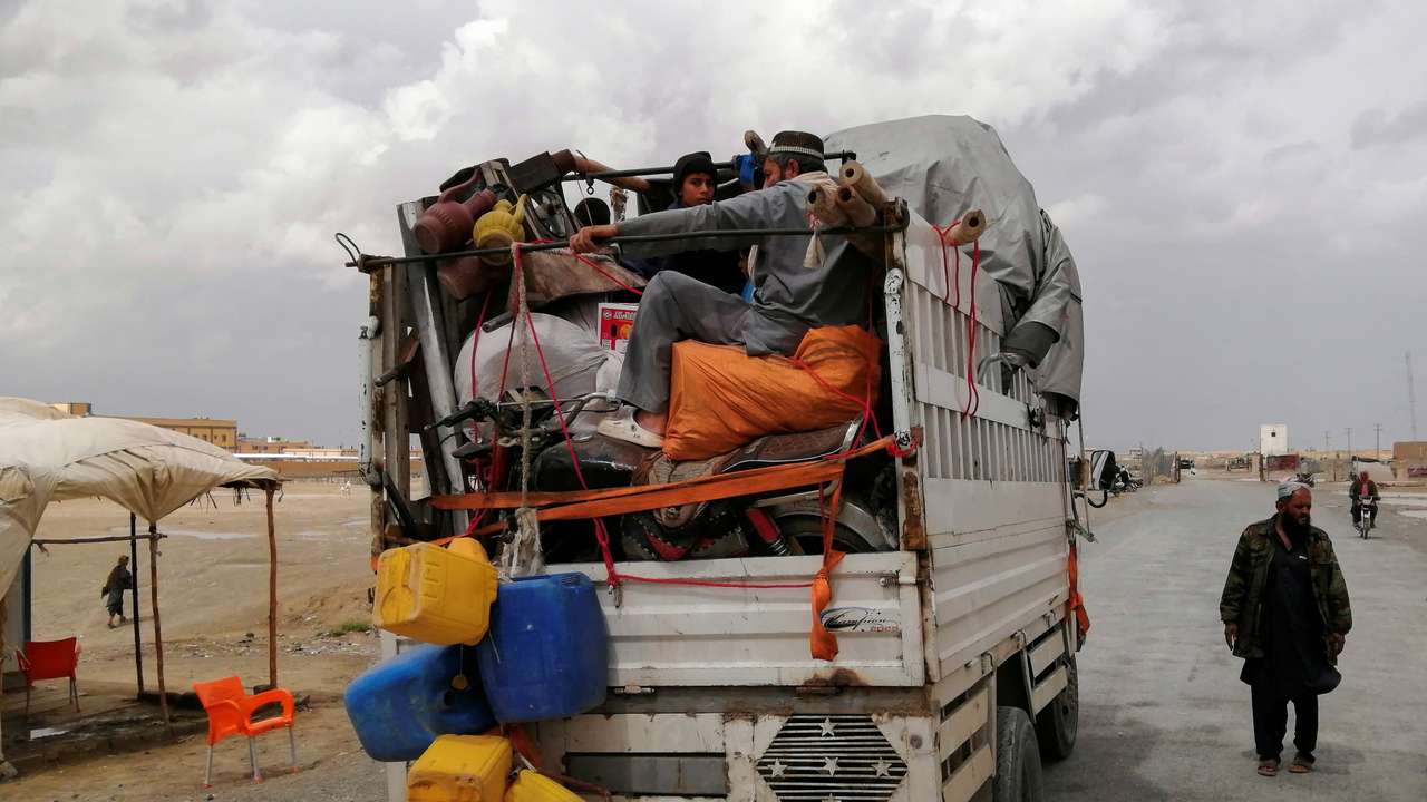 An Afghan family travels with their belongings in a vehicle as they leave for their country at the Chaman border crossing