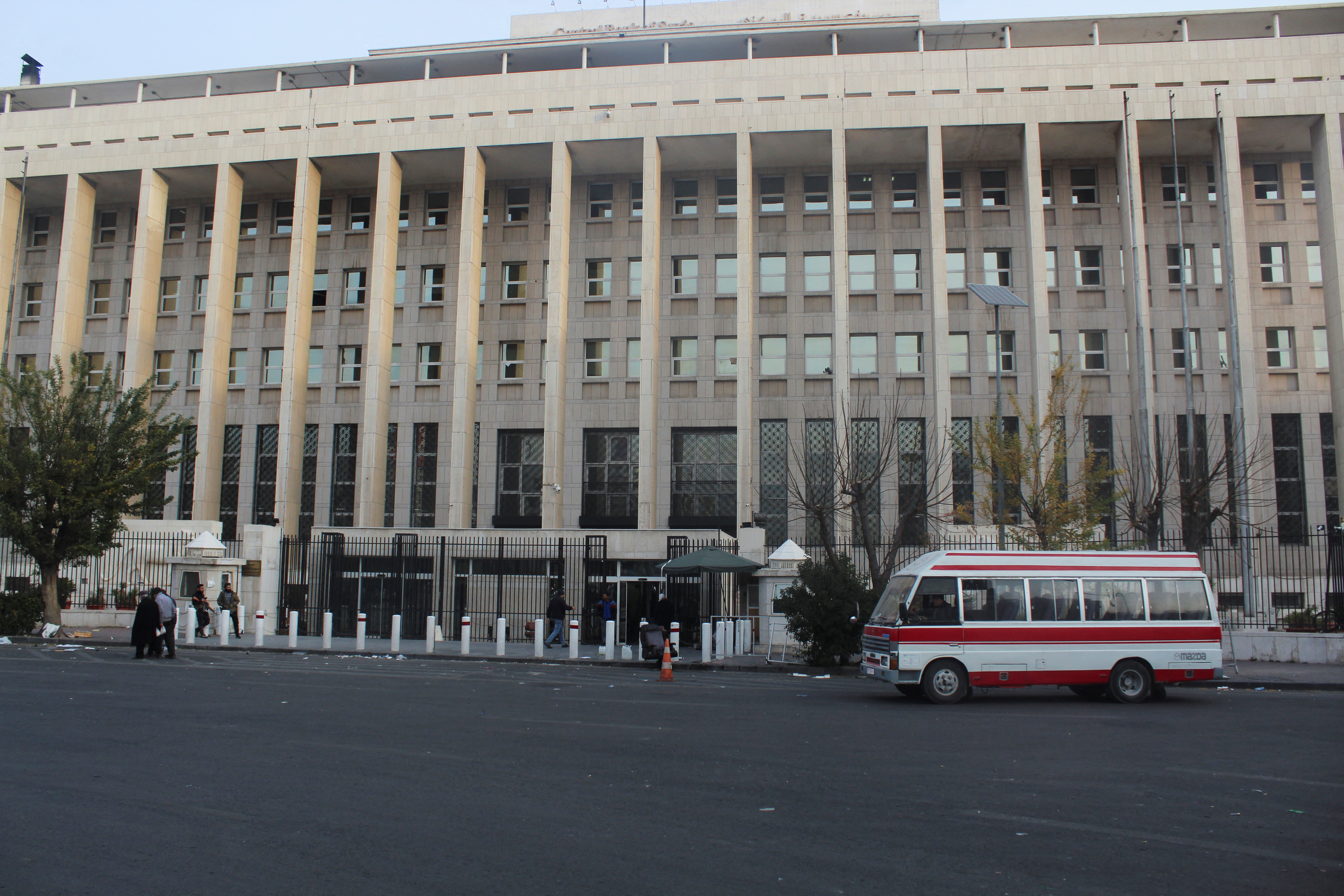 Employees enter the Syrian Central Bank as they return to work
