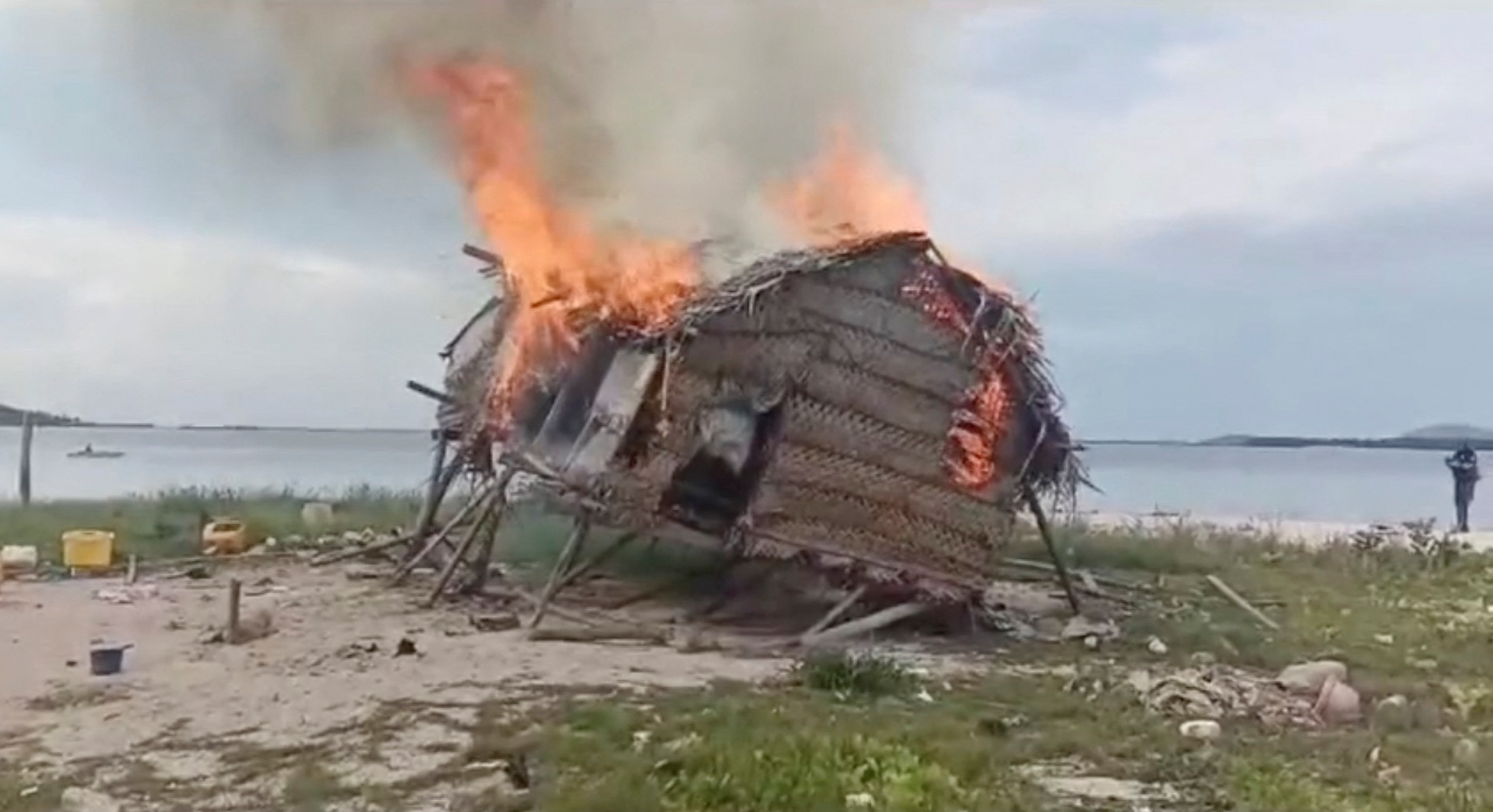 Smoke rises as a house is demolished in Tun Sakaran Marine Park, Sabah