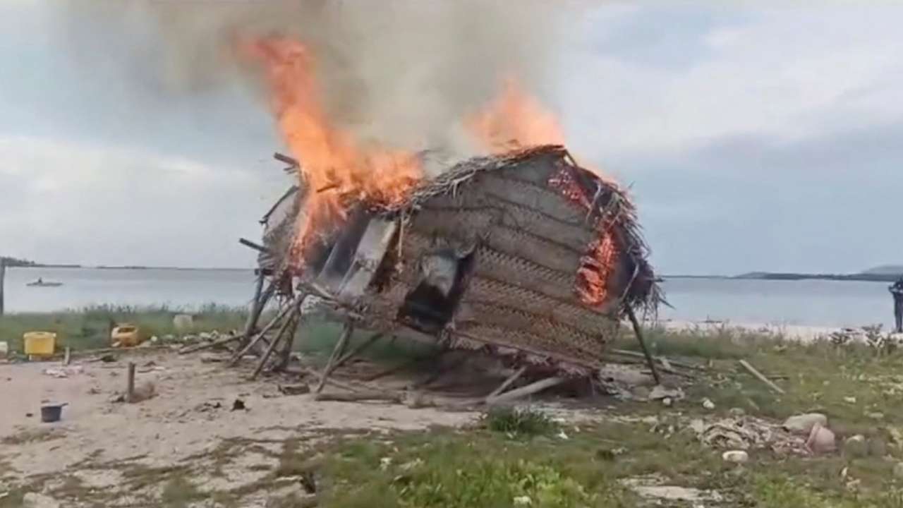 Smoke rises as a house is demolished in Tun Sakaran Marine Park, Sabah