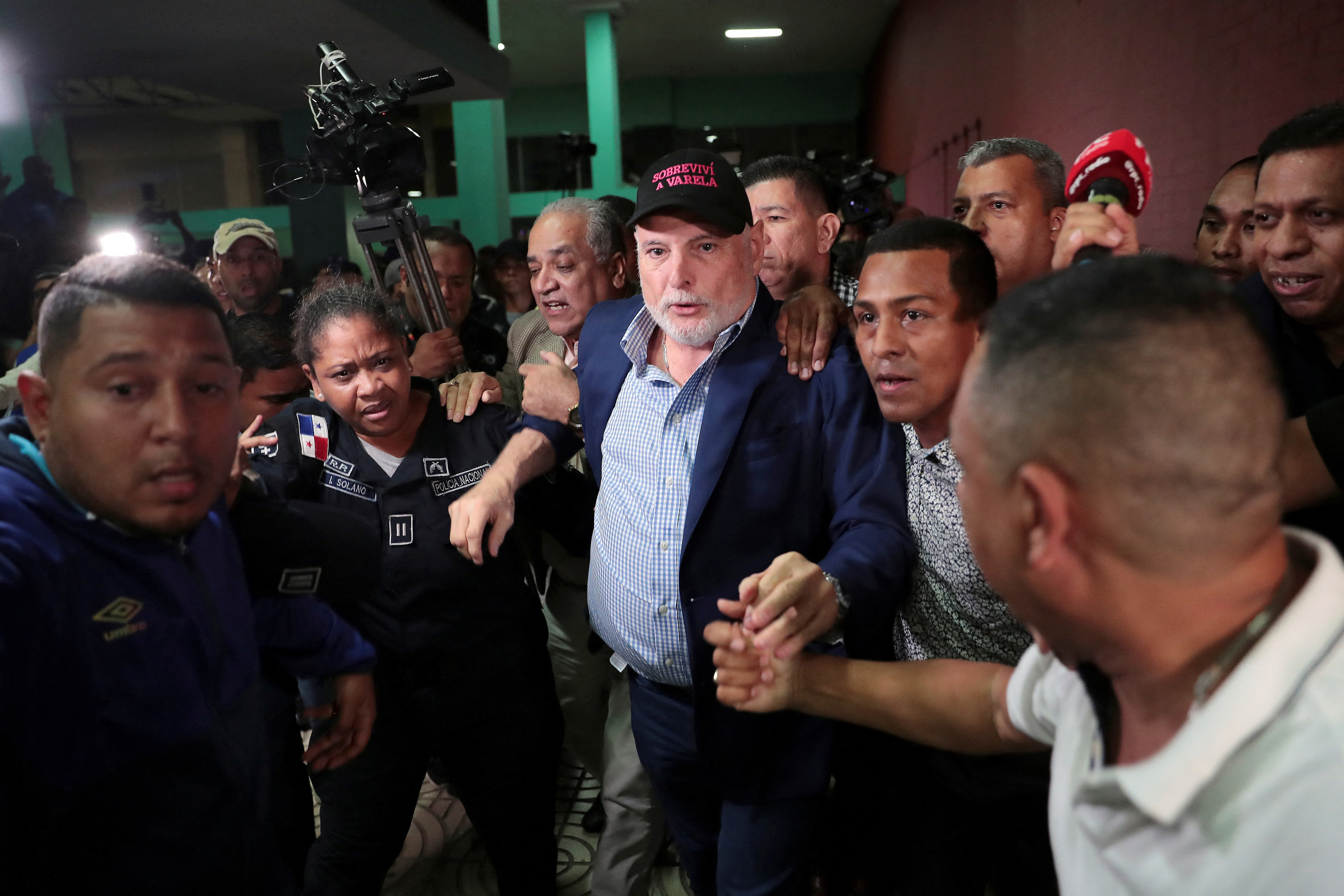 FILE PHOTO: Panama's former President Ricardo Martinelli is escorted by police officers and supporters while leaving a courthouse in Panama City