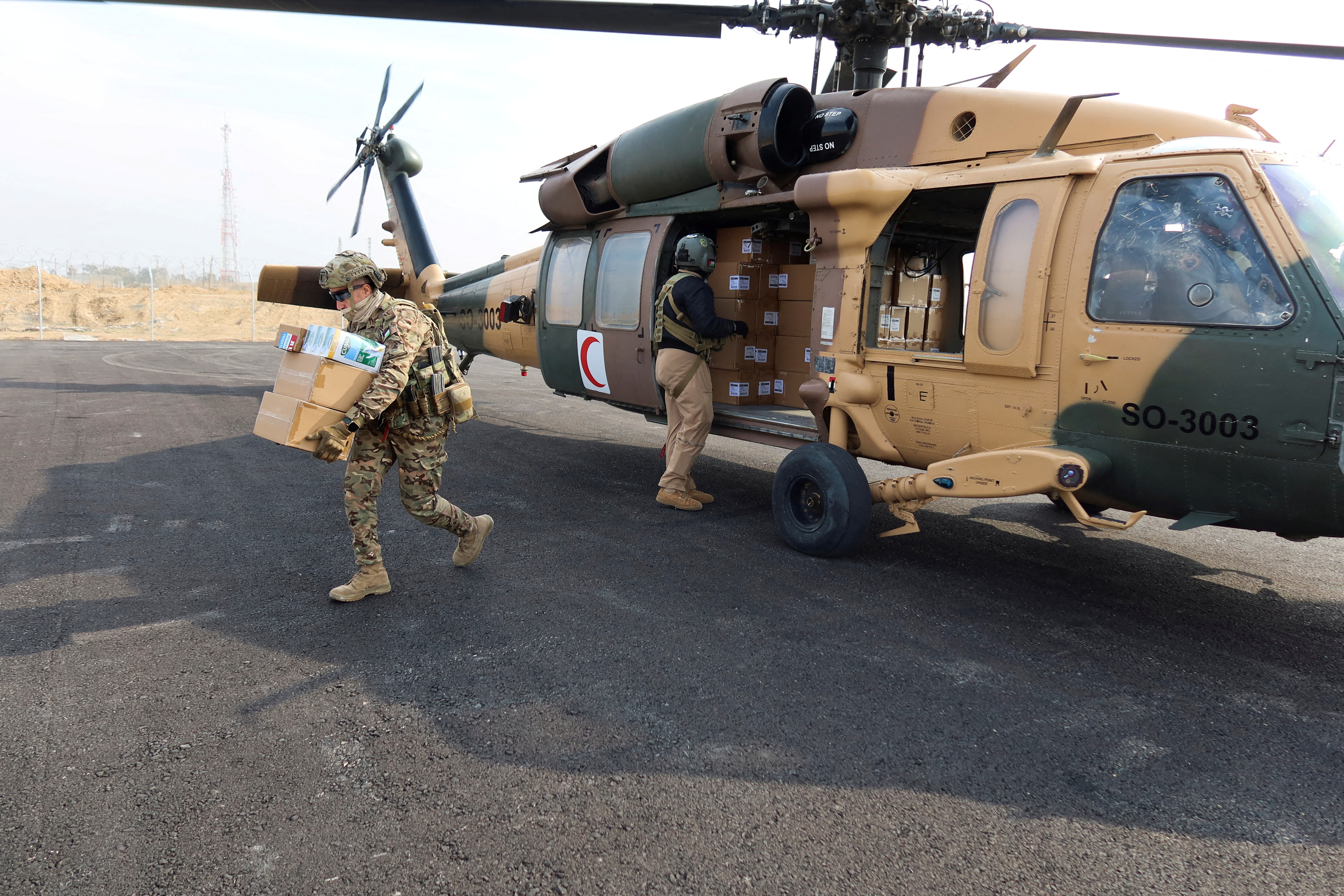 Members of the Jordanian air forces unload aid for the people of Gaza at Kissufim Crossing