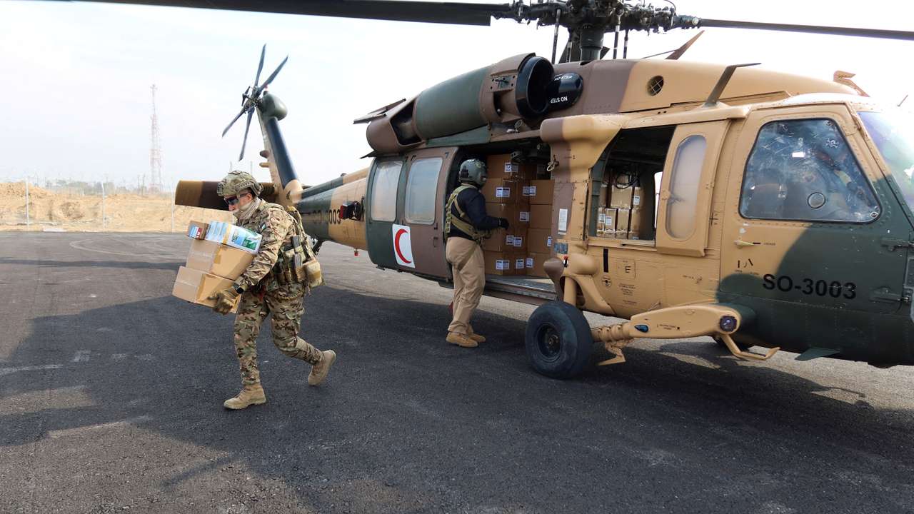 Members of the Jordanian air forces unload aid for the people of Gaza at Kissufim Crossing