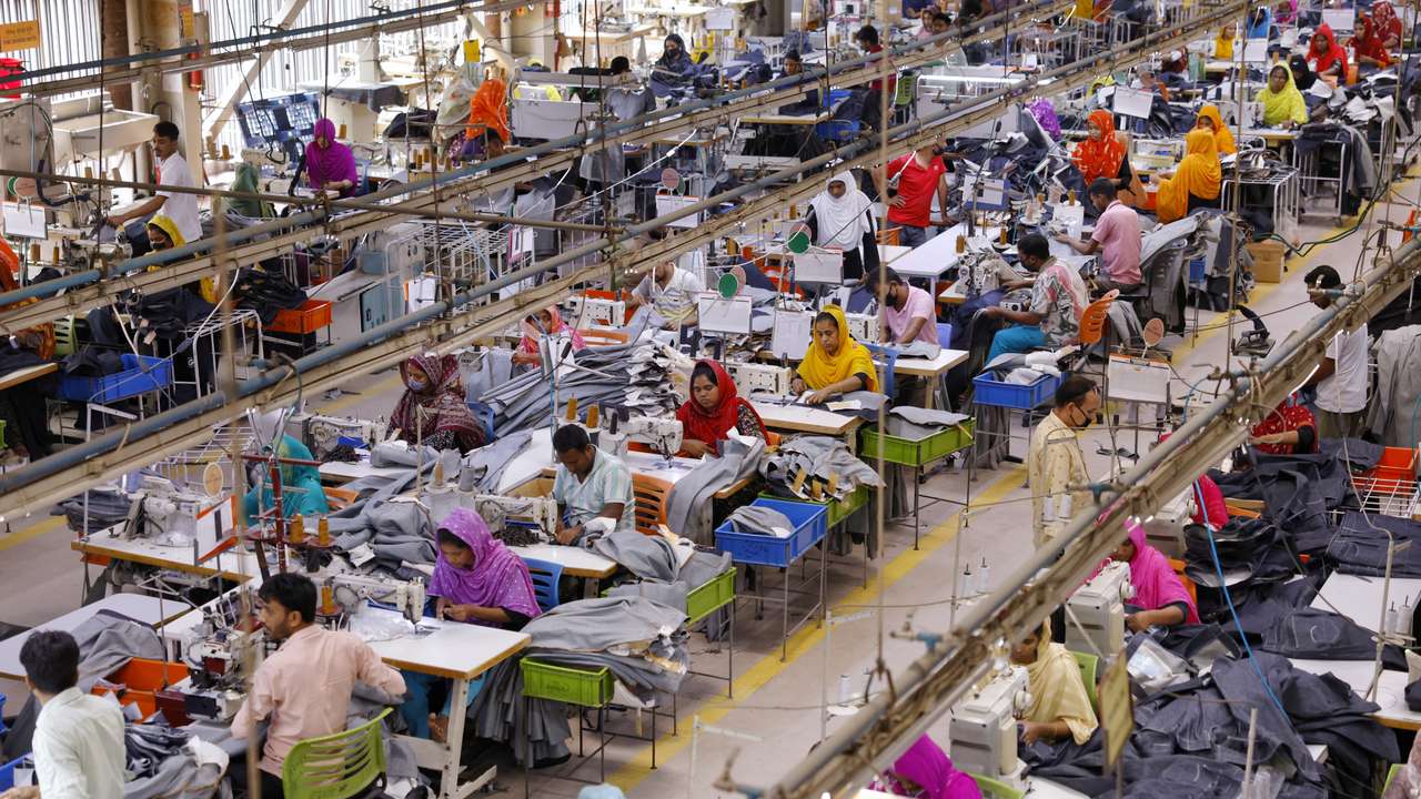 Bangladeshi garment workers sew at a textile factory in Gazipur