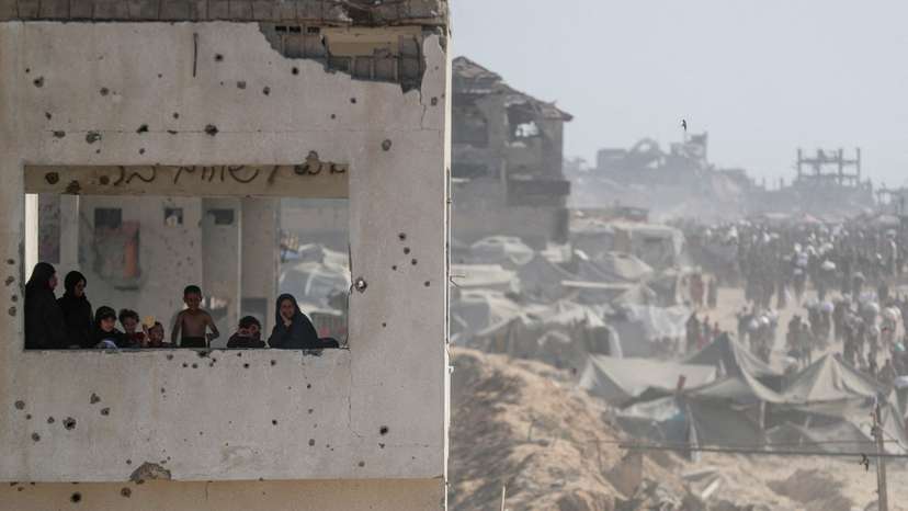 Palestinians carry aid supplies that entered Gaza through Israel, in Beit Lahia