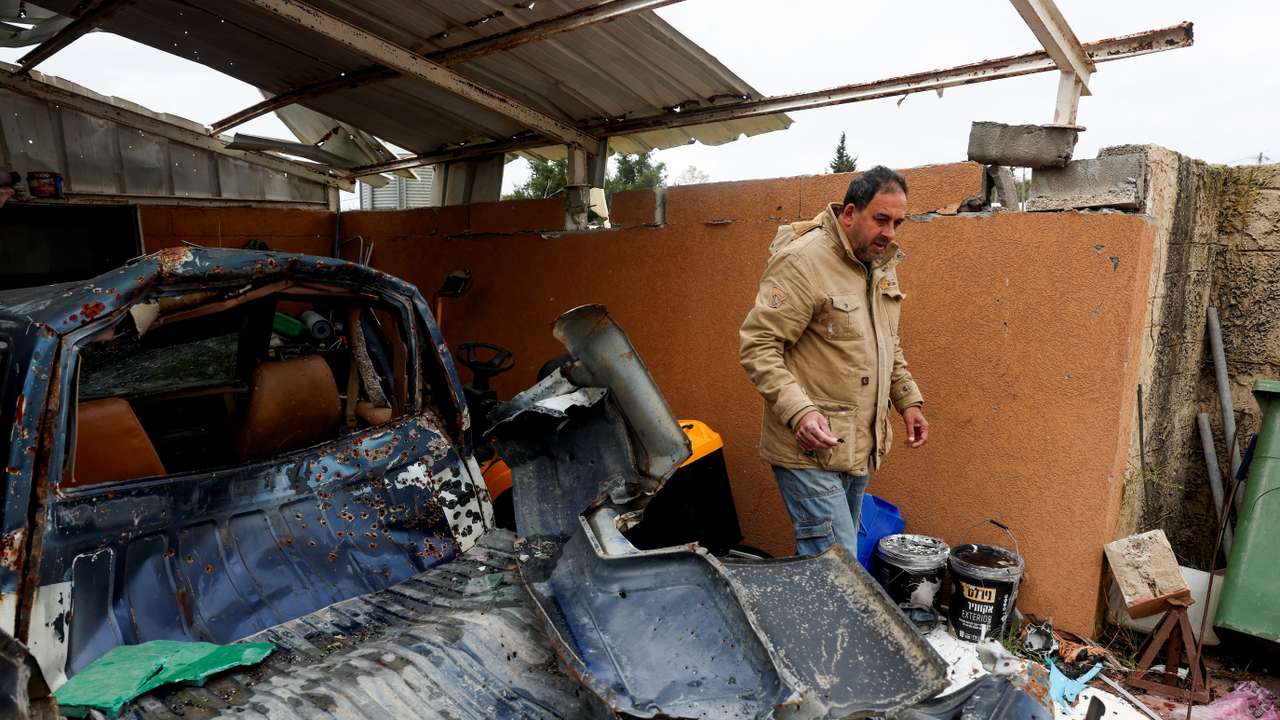 Itzik Ben Moha walks past his damaged car, after a ceasefire was agreed to by Israel and Iran-backed Hezbollah in Lebanon, in Zar'it