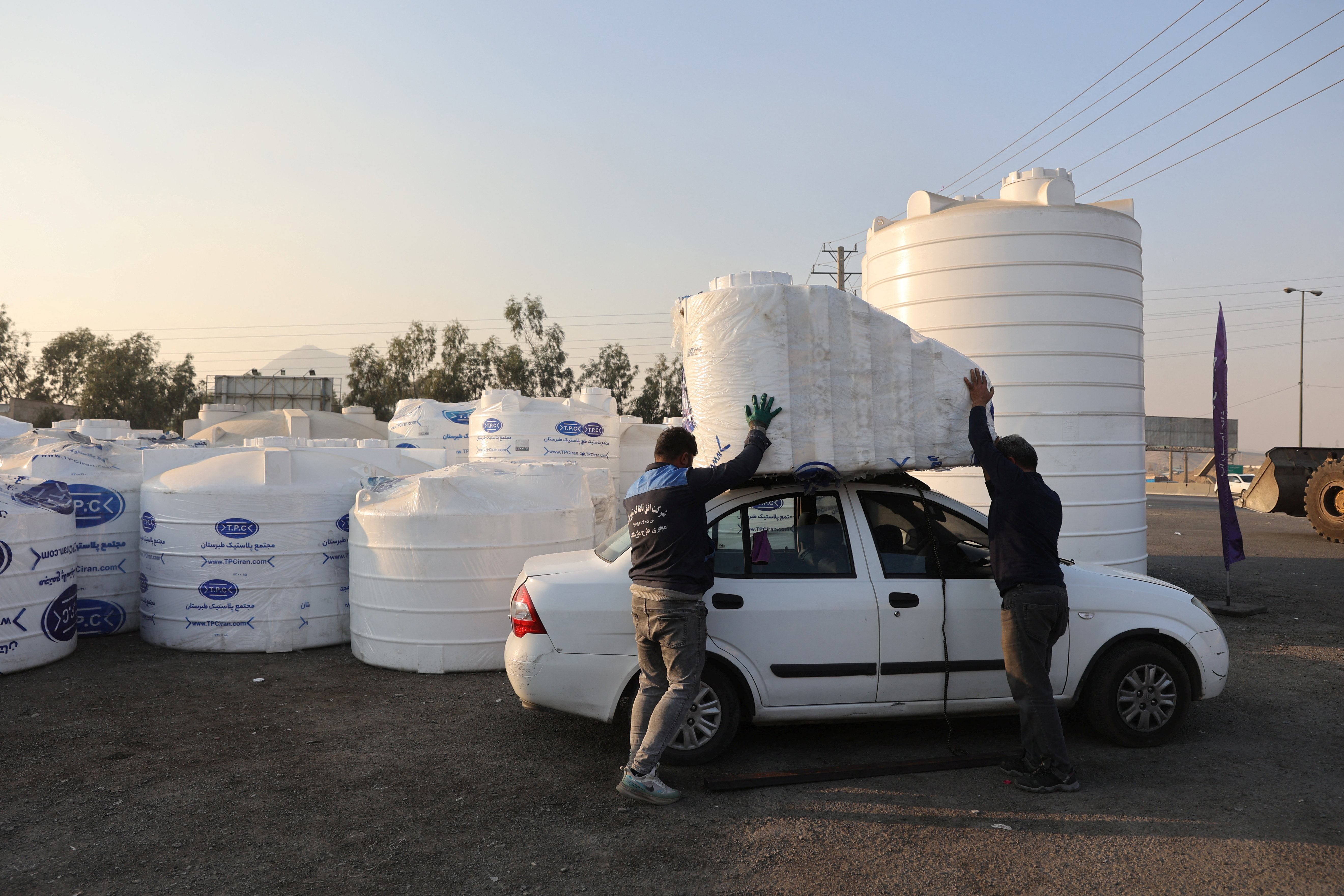 People shop water storage tanks following a drought crisis in Tehran