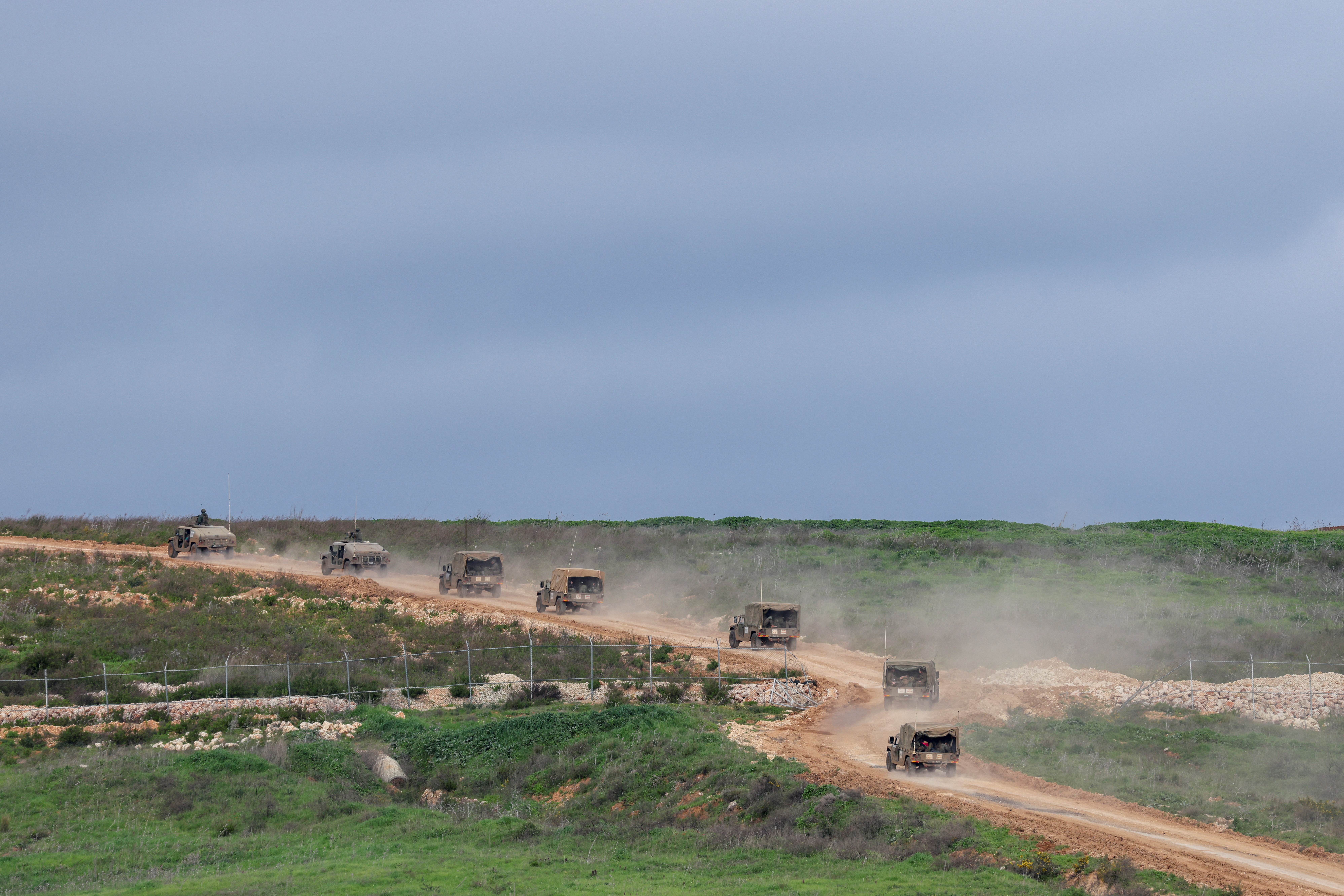 Israeli military jeeps drive to the border with Lebanon in northern Israel