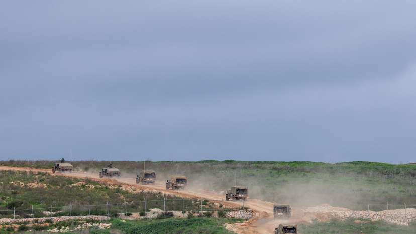 Israeli military jeeps drive to the border with Lebanon in northern Israel