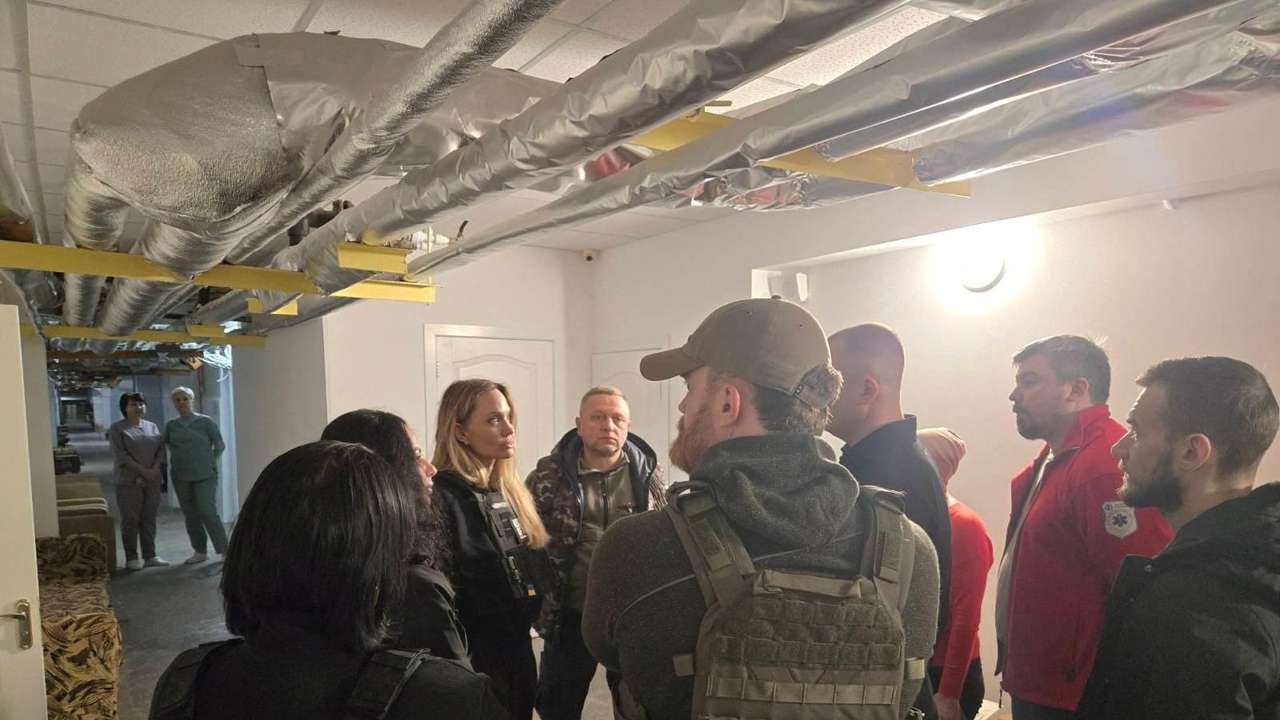 Angelina Jolie and others indoors with flak jackets, in Kherson