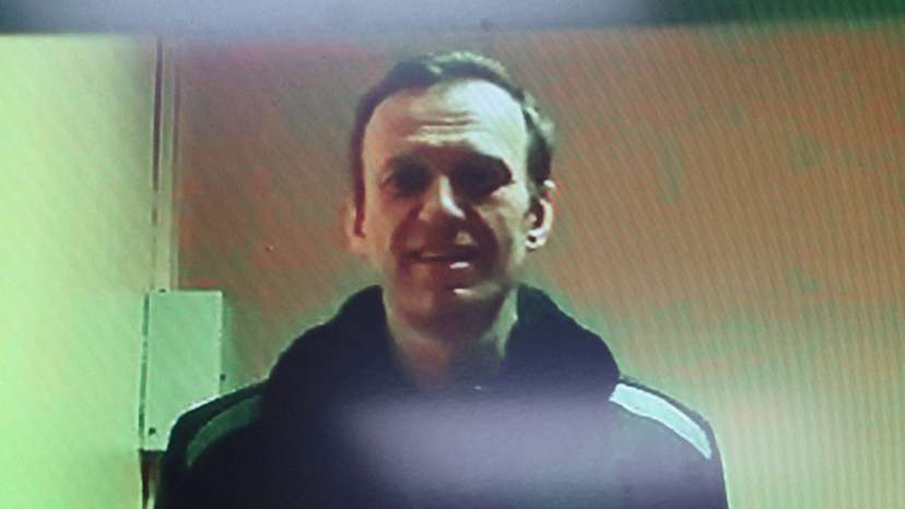 FILE PHOTO: Russian opposition leader Alexei Navalny is seen on a screen via video link during a court hearing in Moscow