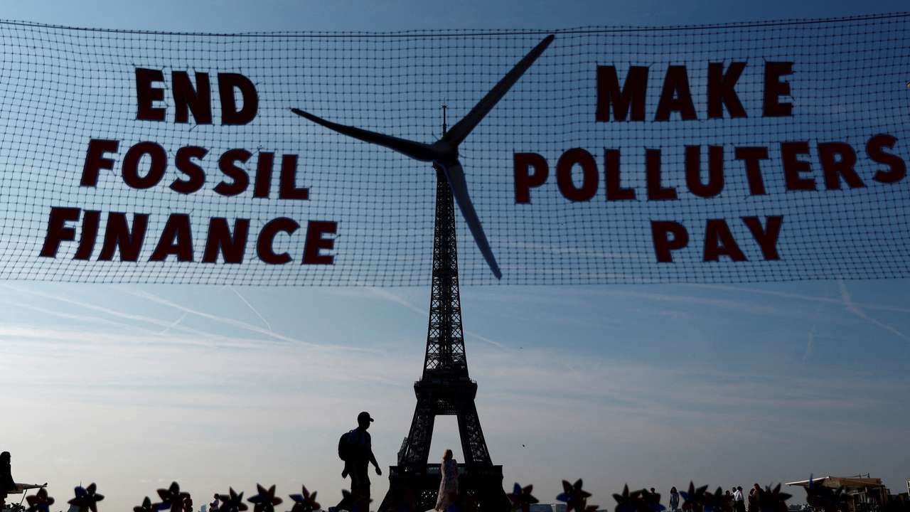 Activists turn Eiffel Tower into giant wind turbine to welcome world leaders in Paris