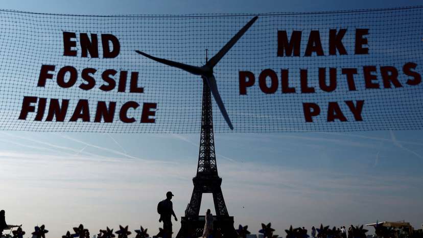 Activists turn Eiffel Tower into giant wind turbine to welcome world leaders in Paris