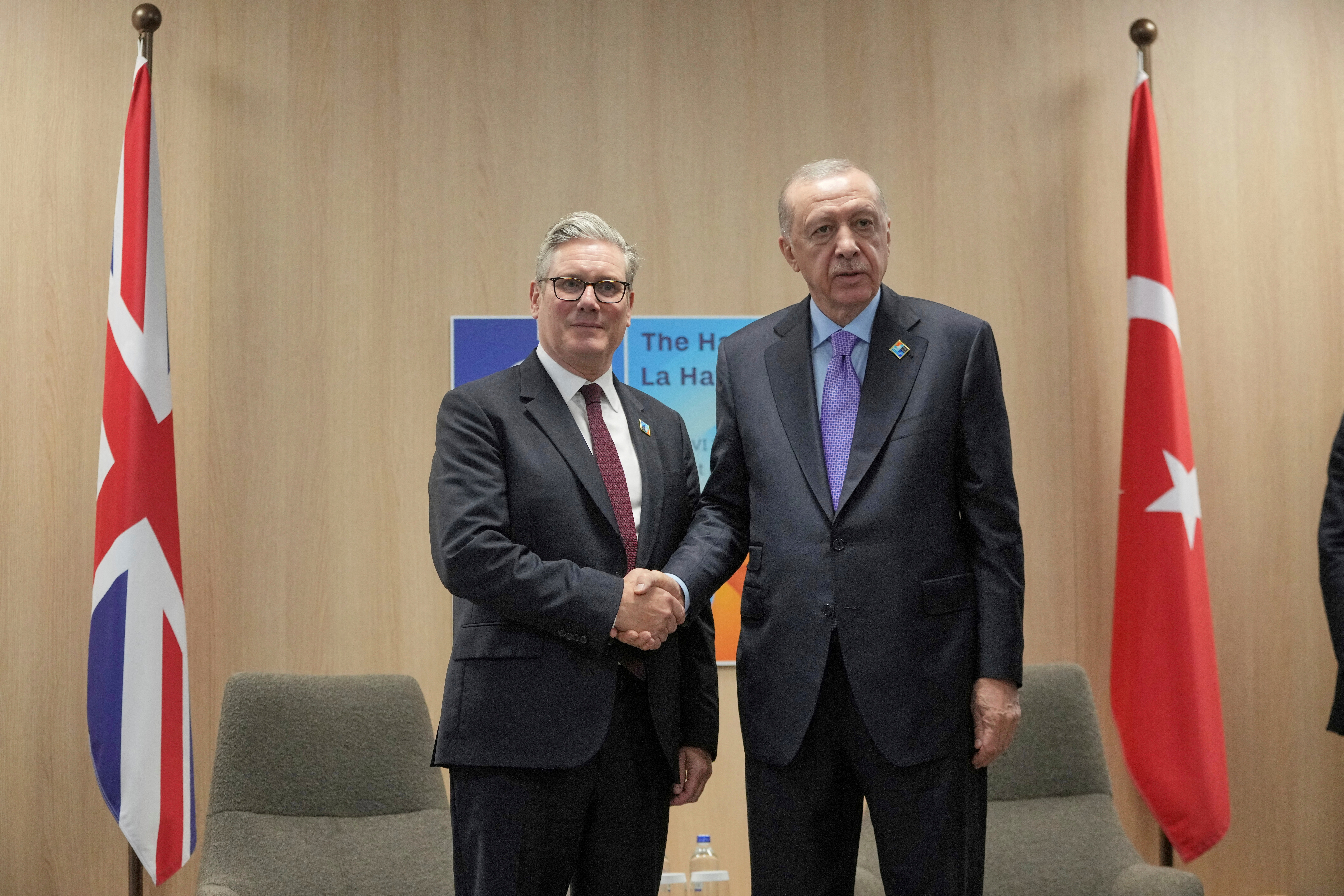 Turkey's President Recep Tayyip Erdogan and Britain's Prime Minister Keir Starmer shake hands during a bilateral meeting at the NATO summit in The Hague