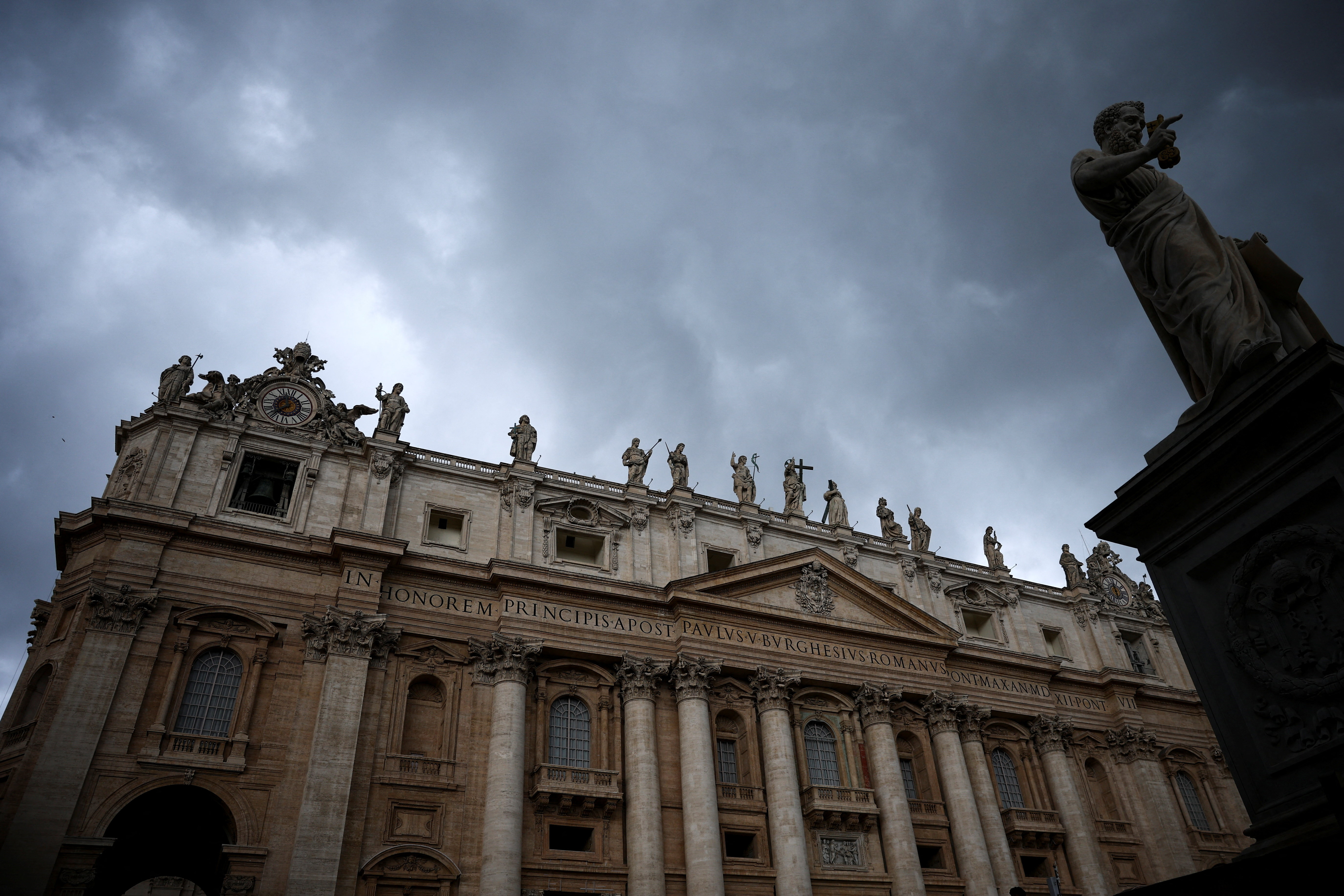 View of the statue of Saint Peter and St. Peter's Basilica, at the Vatican
