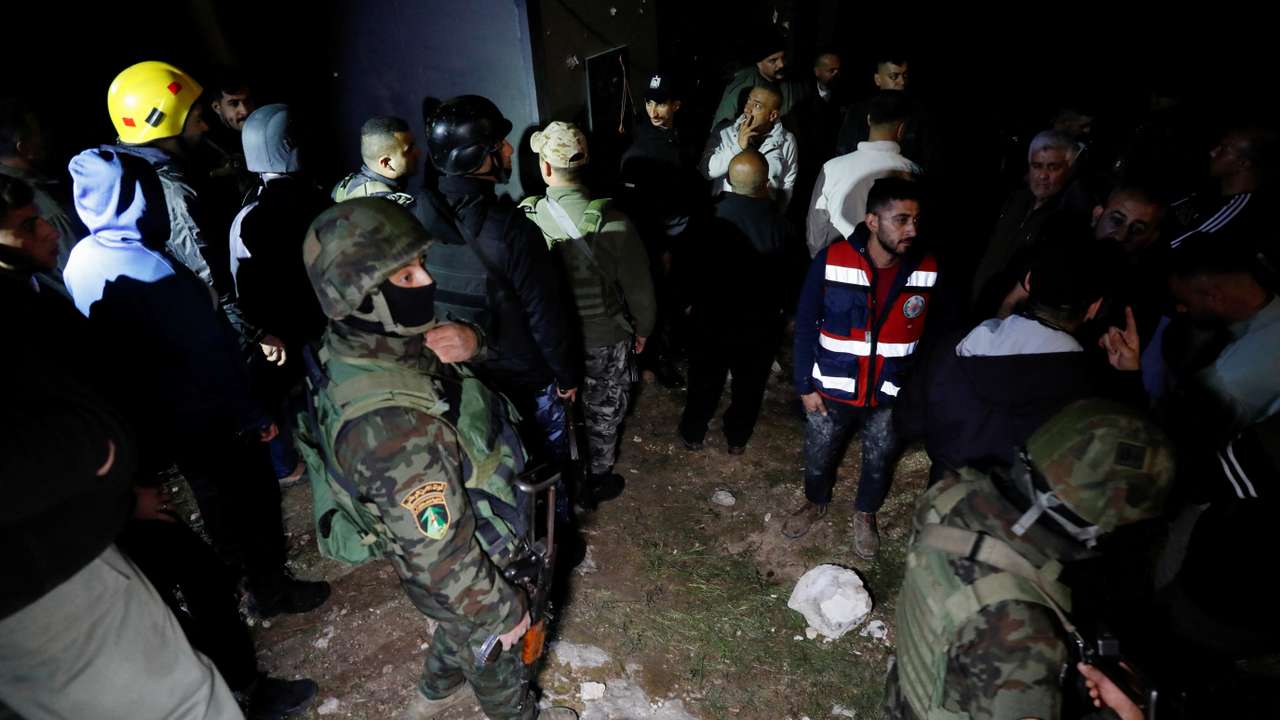 Palestinian security forces gather at the scene where Palestinian women were killed in an Iranian missile attack near Hebron