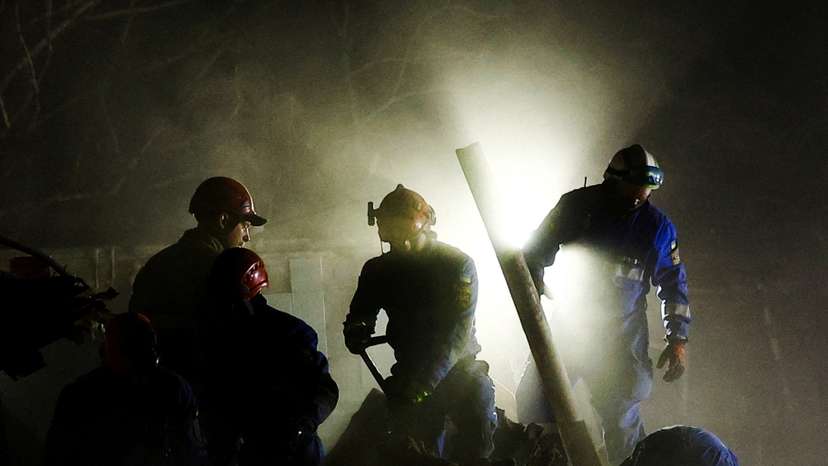 Rescuers work at the site of an apartment building hit by a Russian ballistic missile strike, in Kyiv