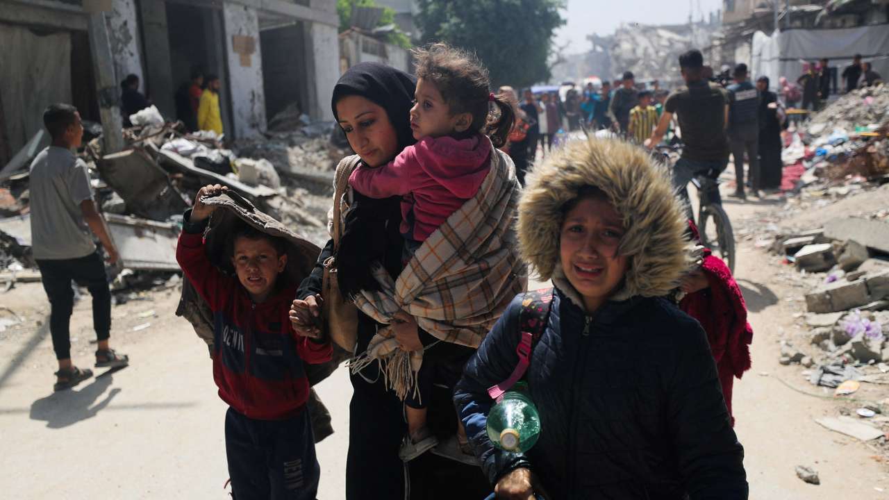 Palestinians flee their homes after the Israeli army issued evacuation orders, in Gaza City