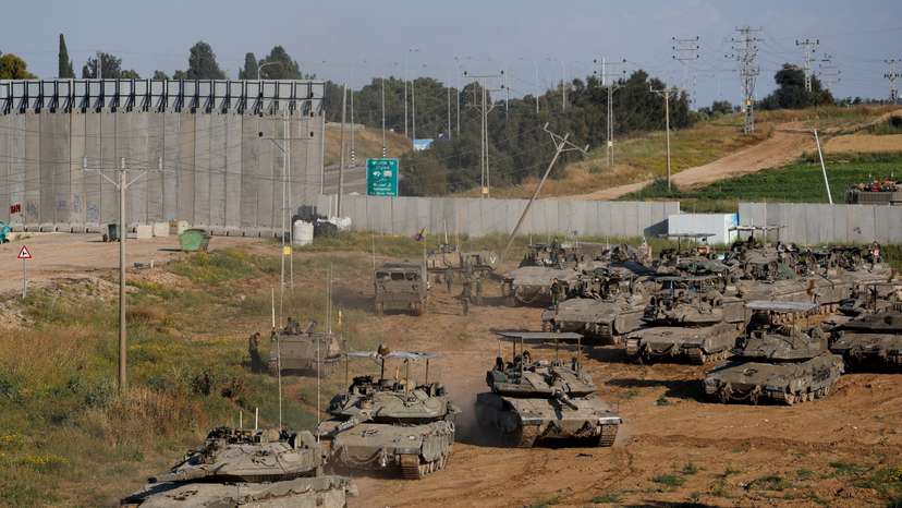 Israeli soldiers prepare near the Israel-Gaza border