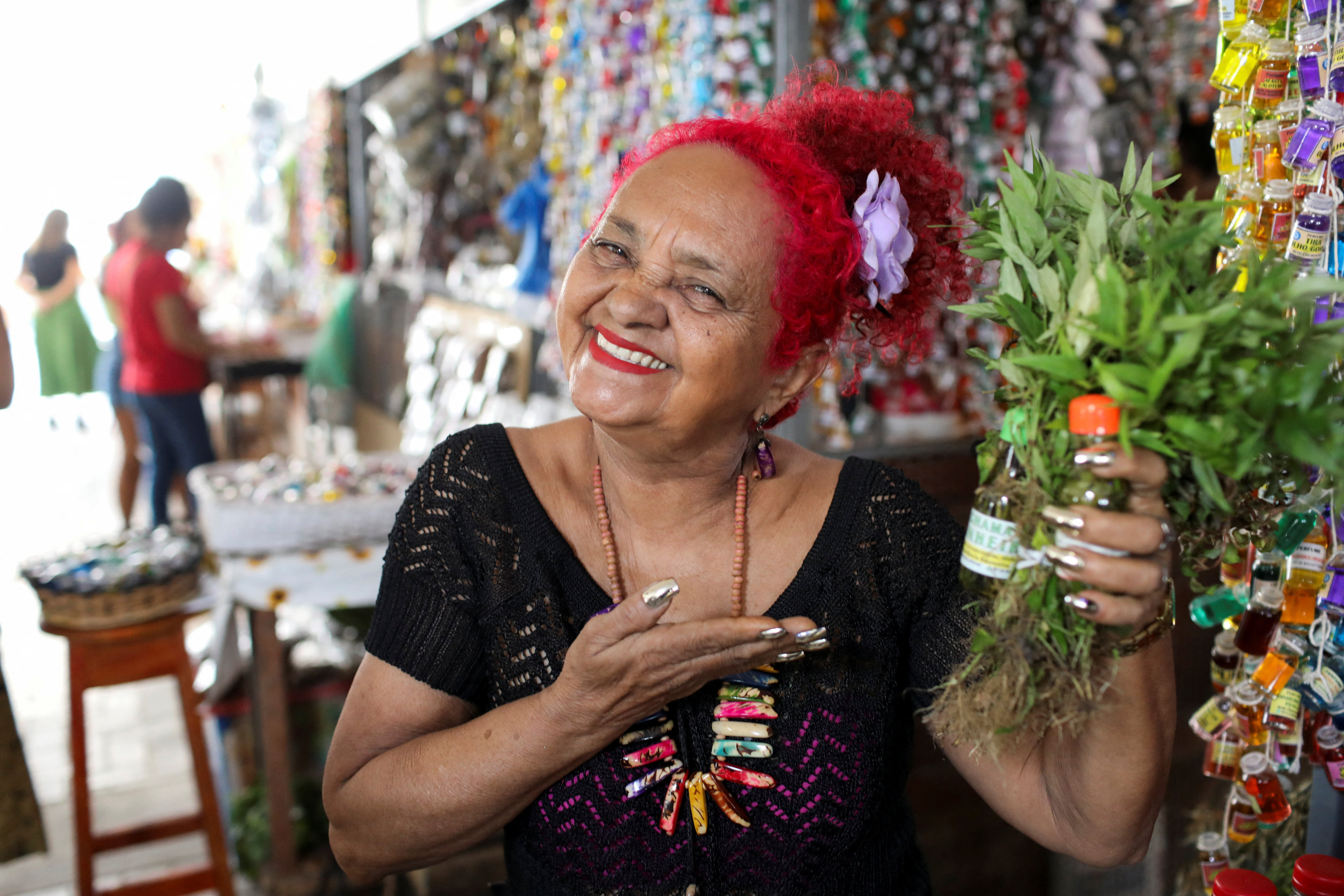 Beth Cheirosinha, who sells products based on aromatic and medicinal herbs from the Amazon, poses for a picture in Belem