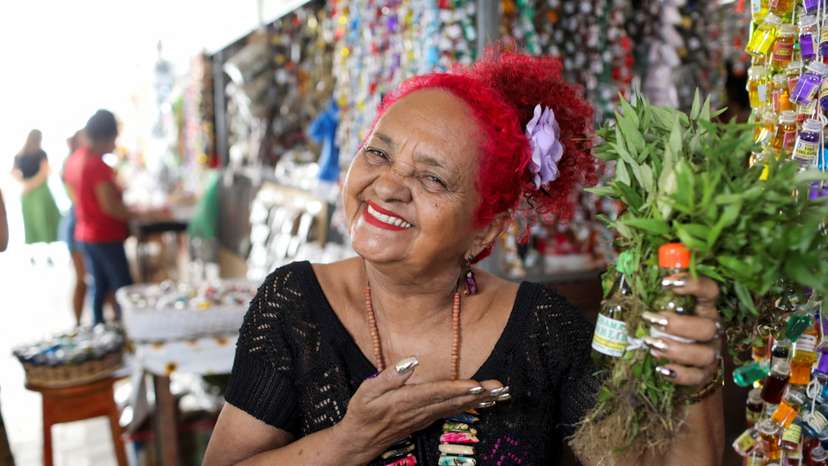 Beth Cheirosinha, who sells products based on aromatic and medicinal herbs from the Amazon, poses for a picture in Belem