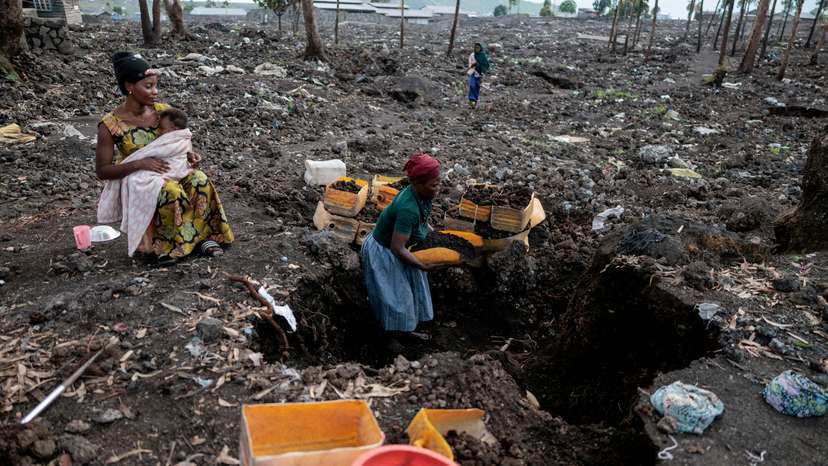 FILE PHOTO: Kahindo, an internally displaced woman, gathers volcanic gravel to sell at Lushagala IDP’s camp near Goma