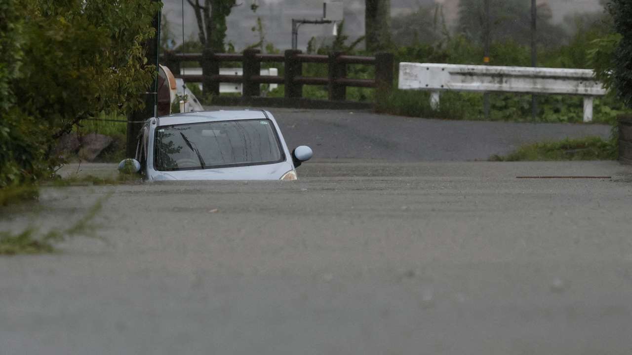 FILE PHOTO: A car is submerged at a flooded area due to heavy rains from Typhoon Shanshan in Yufu, Oita Prefecture, southwestern Japan