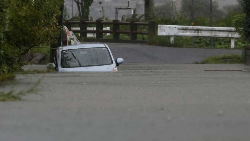 FILE PHOTO: A car is submerged at a flooded area due to heavy rains from Typhoon Shanshan in Yufu, Oita Prefecture, southwestern Japan