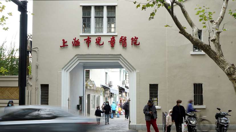 People stand outside a children's hospital in Shanghai